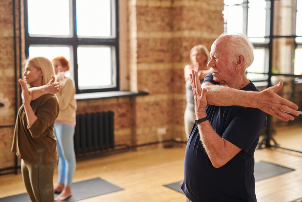 Senior people exercising in health club